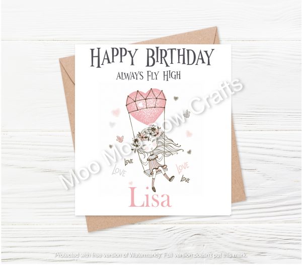 girl on swing with balloon heart