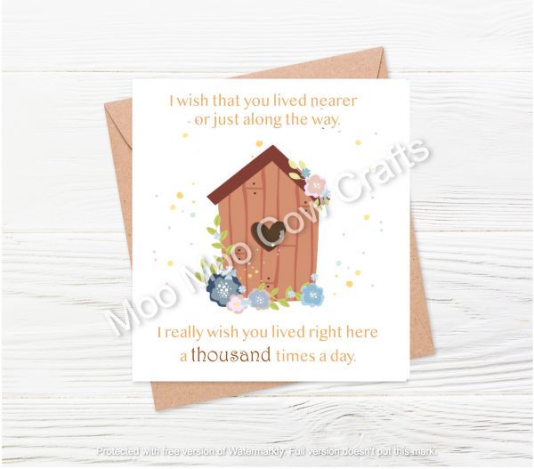 house with text on white card and wooden background