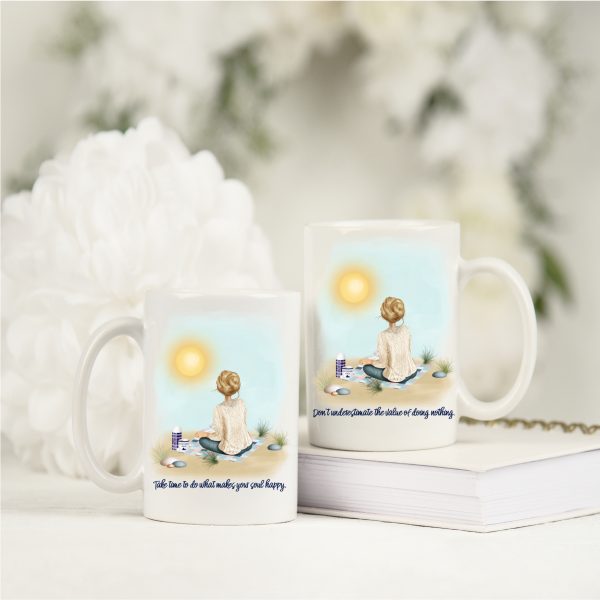 two mugs on white book with white flowers