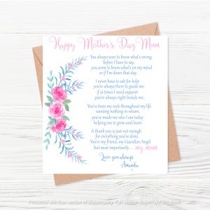 text with pink flowers and brown envelope on wooden background