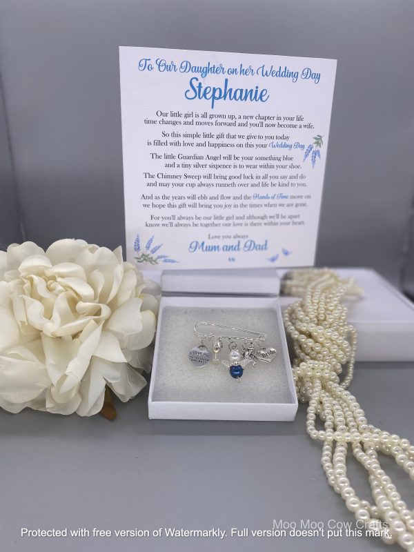 charms on kilt pin with a card, flowers and pearls