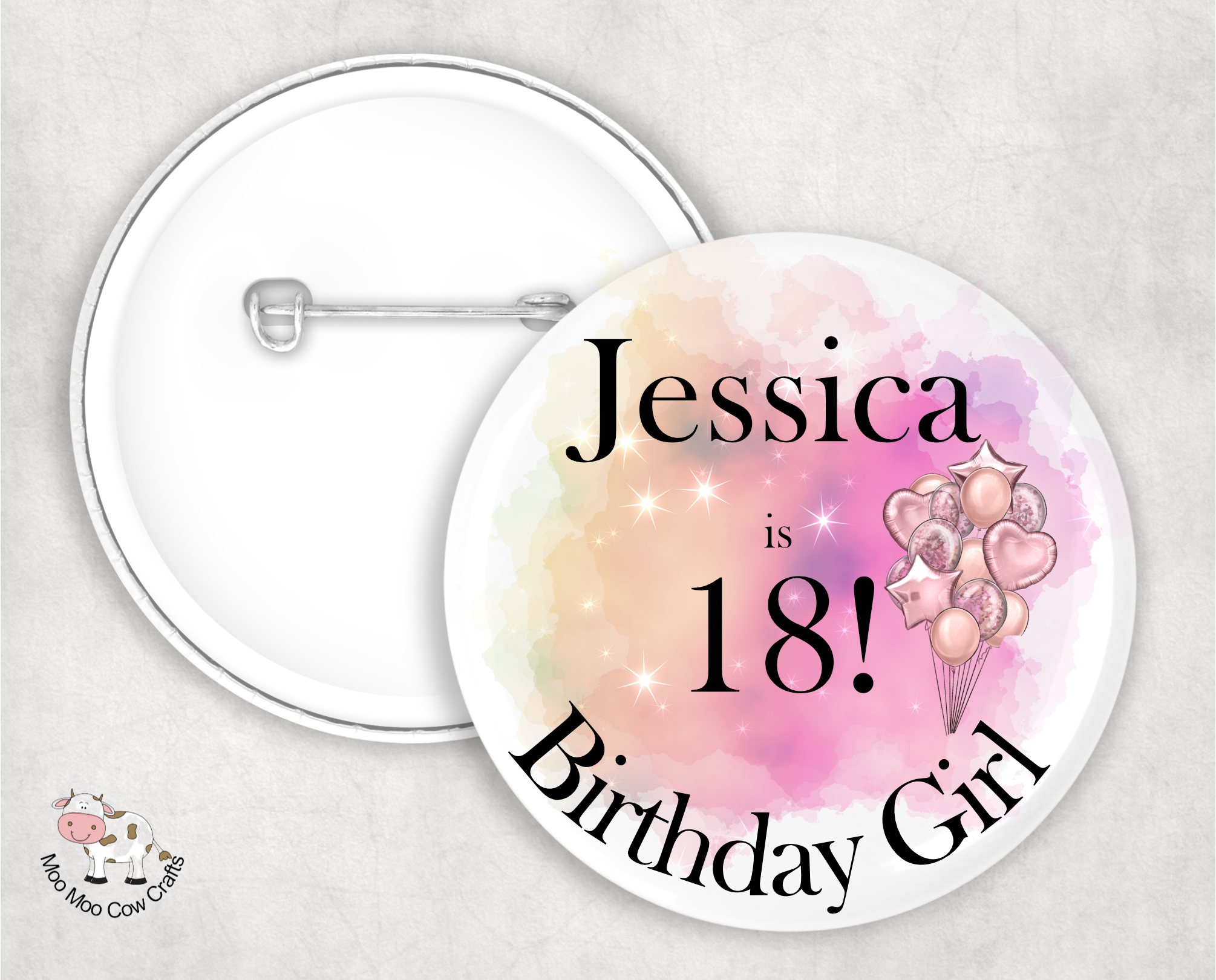 metal pin badge with image of balloons and text on a white wooden background.