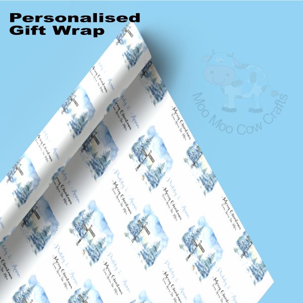 Blue background with white roll of wrapping paper in blue christmas pattern