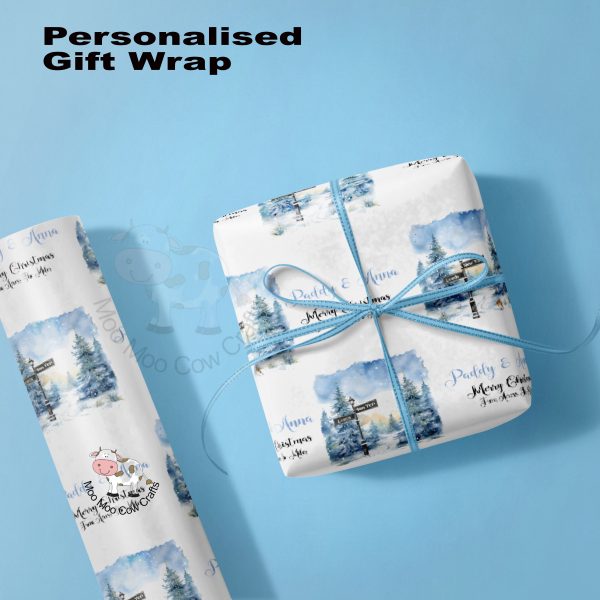 Blue background with gift box and roll of wrapping paper with blue christmas theme.