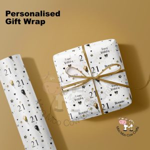 Wrapped gift and wrapping paper roll on gold background.