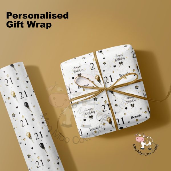 Wrapped gift and wrapping paper roll on gold background.