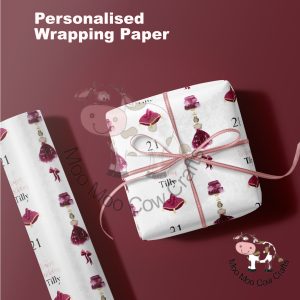 gift box and roll of gift wrap on burgundy background