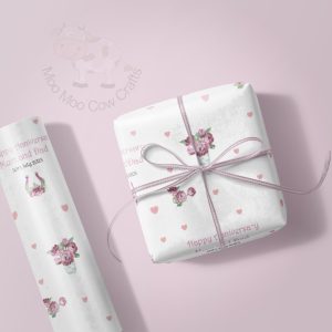 lilac background with wrapping paper rol and gift box
