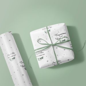 wrapping paper roll and gift box on green background
