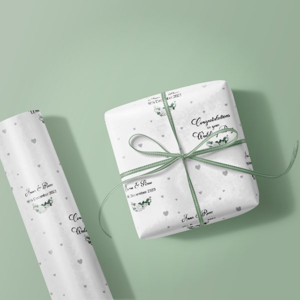 wrapping paper roll and gift box on green background