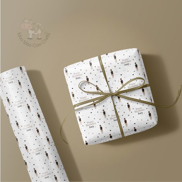 gift wrapped present and a roll of wrapping paper on a taupe background