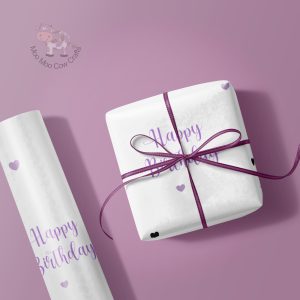 purple background with gift box and wrapping paper roll