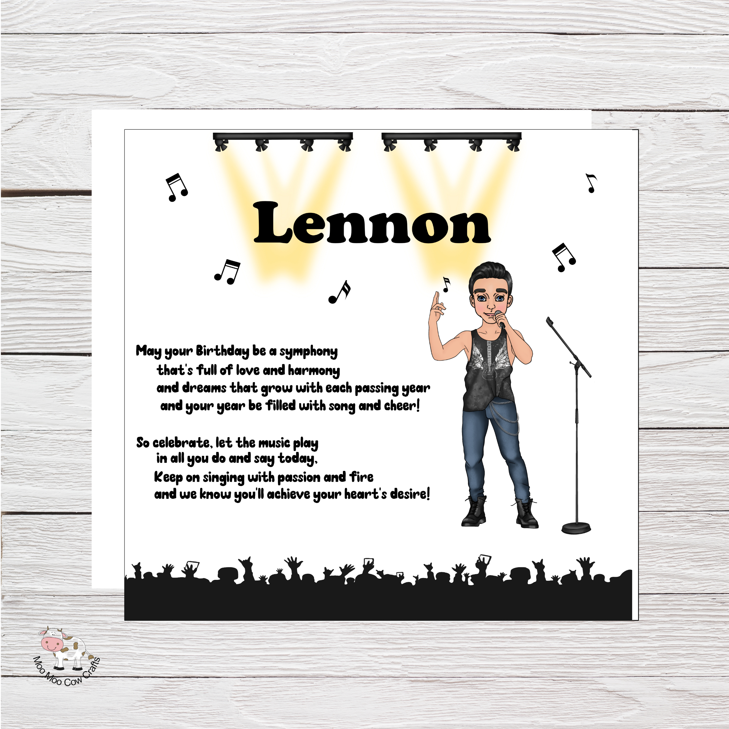 wooden background with a white card with clip art image of a man singing with black text, it's a birthday card