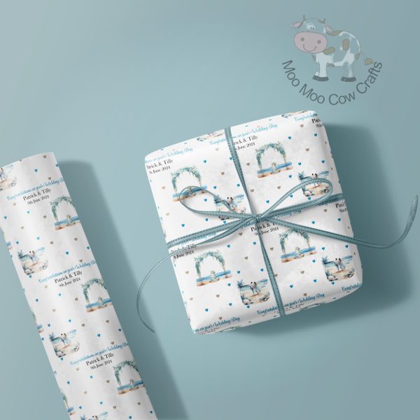 blue background with roll of wrapping paper and gift box in blue wedding repeating pattern.