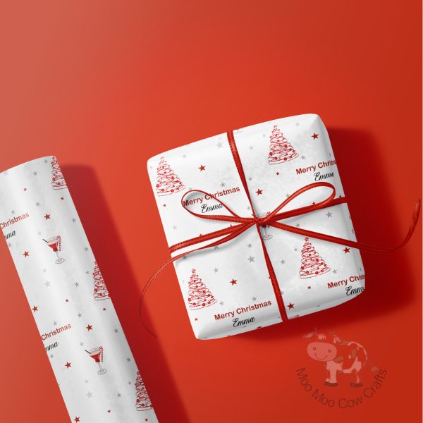 red background with a roll of wrapping paper and a wrapped gift
