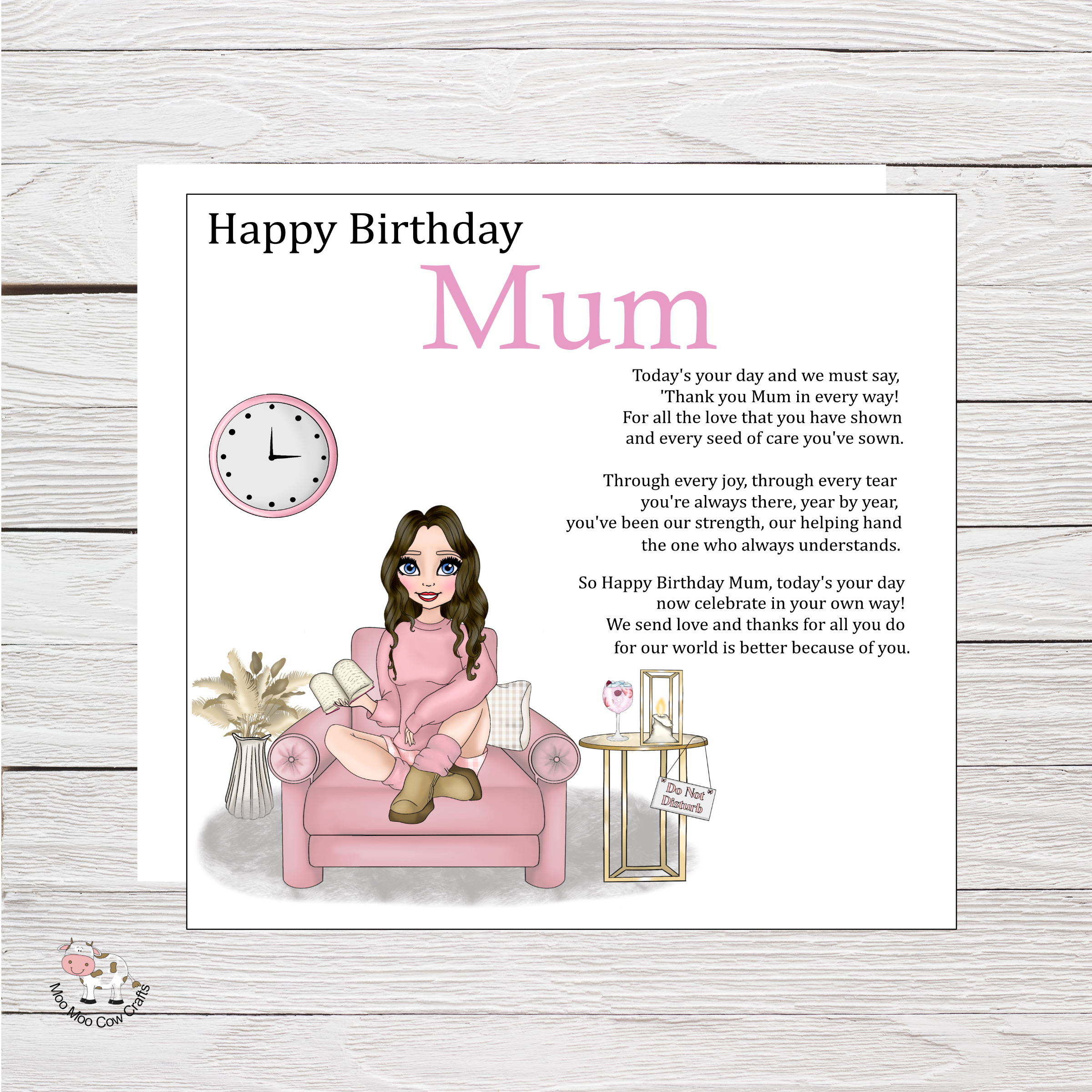 wooden background with white square, clip art image of a woman sitting on a pink chair reading a book. It's a birthday card
