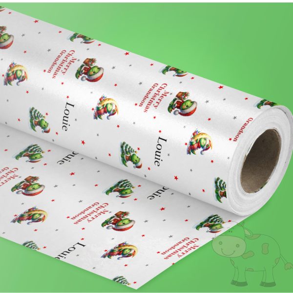 green background with one roll of gift wrap with a dinosaur design, it's Xmas wrapping paper