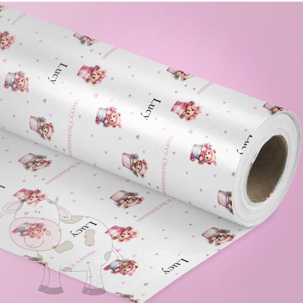 pink background with a roll of wrapping paper with a pink teddies design.