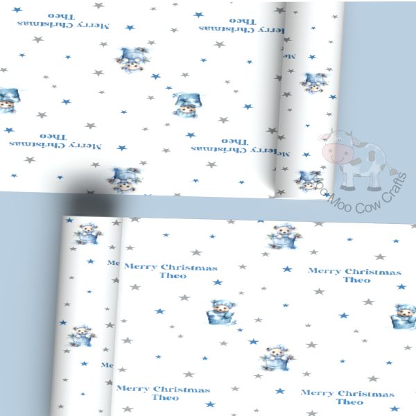 blue background with two rolls of gift wrap with a blue teddy design