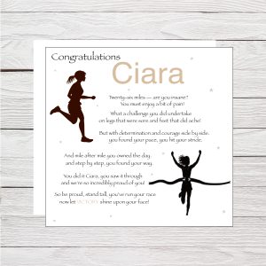 wooden background with white card and black texdt and two silhouette images of a girl running