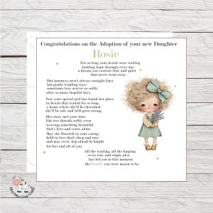 wooden background with white card, clip art image of a little girl and black text - it's a congratulations card for adoption of a little girl