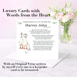 pastel background with a vase of pink and white flowers, there is a greeting card standing on a white envelope with clip art images of geese dressed in clothes with black text, it is a welcome to the world card for a new baby.