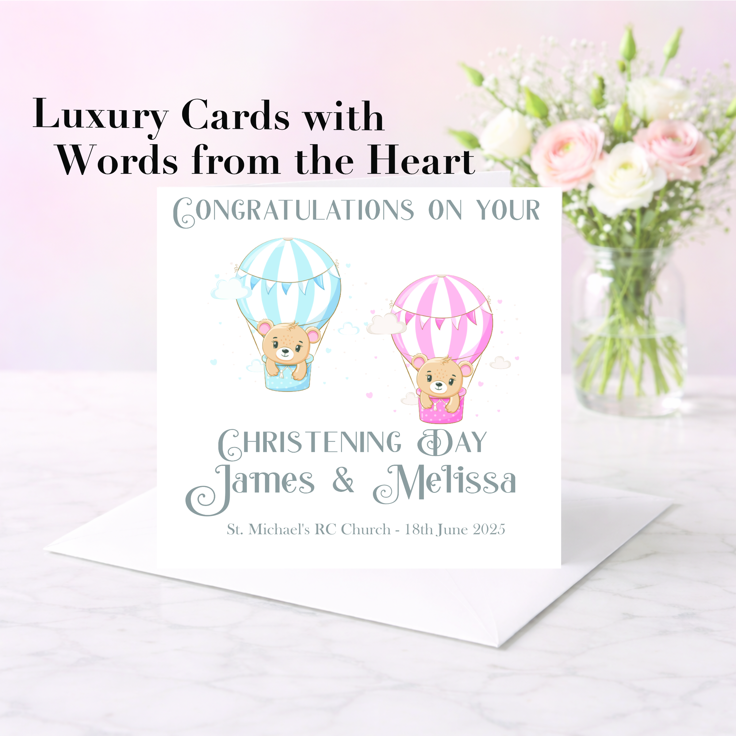 pastel background with a vase of pink and white flowers with a card standing on an envelope, the card has two clip art bears in balloons, one pink and one white. It is a christening card for twin babies.